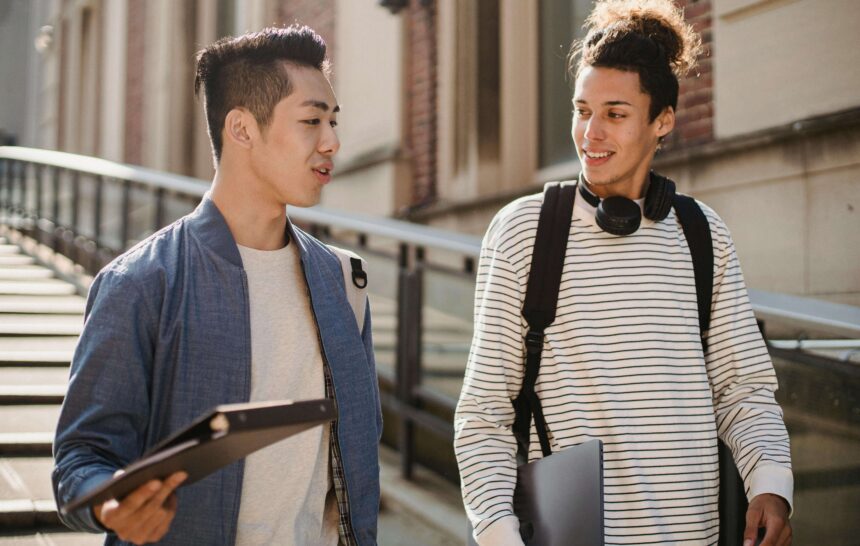40 Questions to Ask Your Potential Roommate (Before You Regret It) two college friends talking while walking